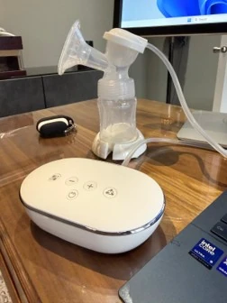 Snookums Electric Breast Pump with bottle, breast shield and control unit on a table