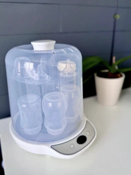 Snookums Electric Steam Steriliser loaded with baby bottles and feeding accessories