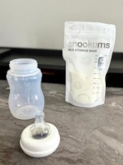 Snookums Breast Milk Storage Bag with baby bottle and teat